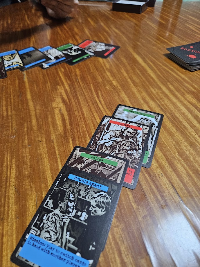 Gameplay photo of the board game Espionage: the card game featuring various components and board state.