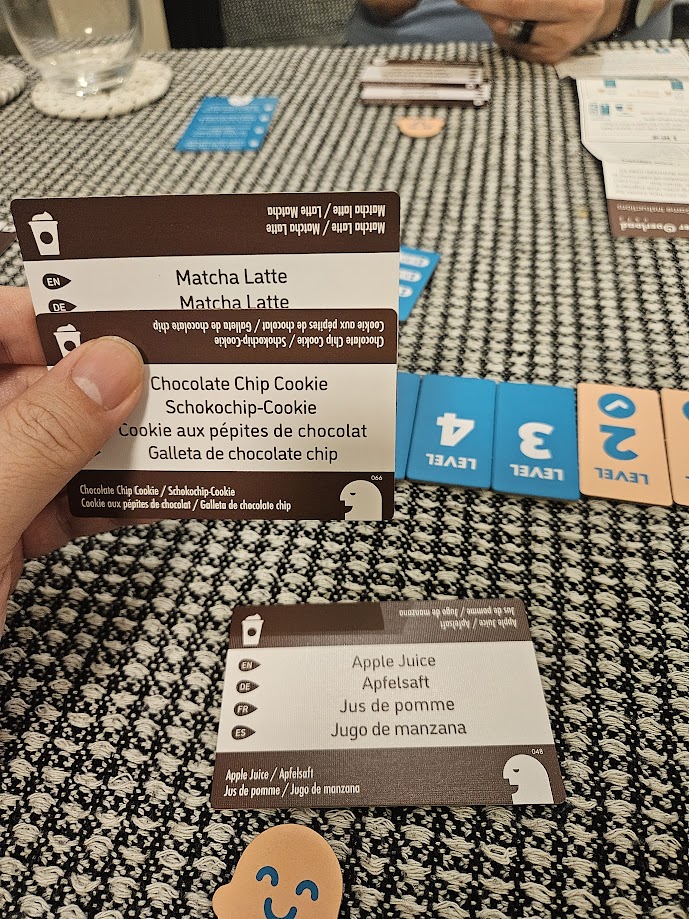 Gameplay photo of the board game Order Overload: Cafe featuring various components and board state.