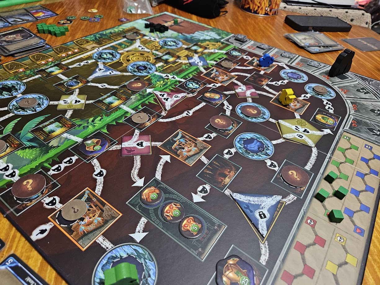 Gameplay photo of the board game Clank! Expeditions: Temple of the Ape Lords featuring various components and board state.