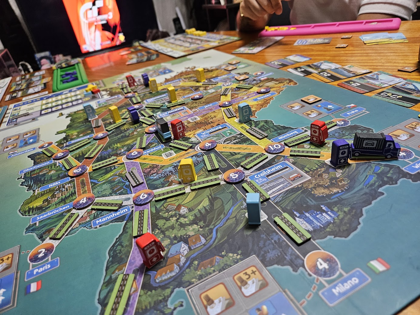 Gameplay photo of the board game Autobahn: Kickstarter Edition featuring various components and board state.
