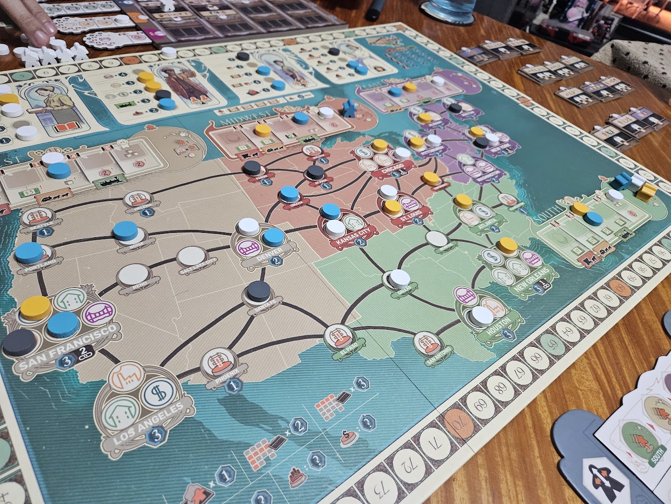 Gameplay photo of the board game Carnegie featuring various components and board state.