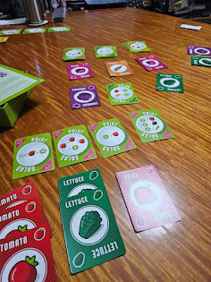 Gameplay photo of the board game Point Salad featuring various components and board state.
