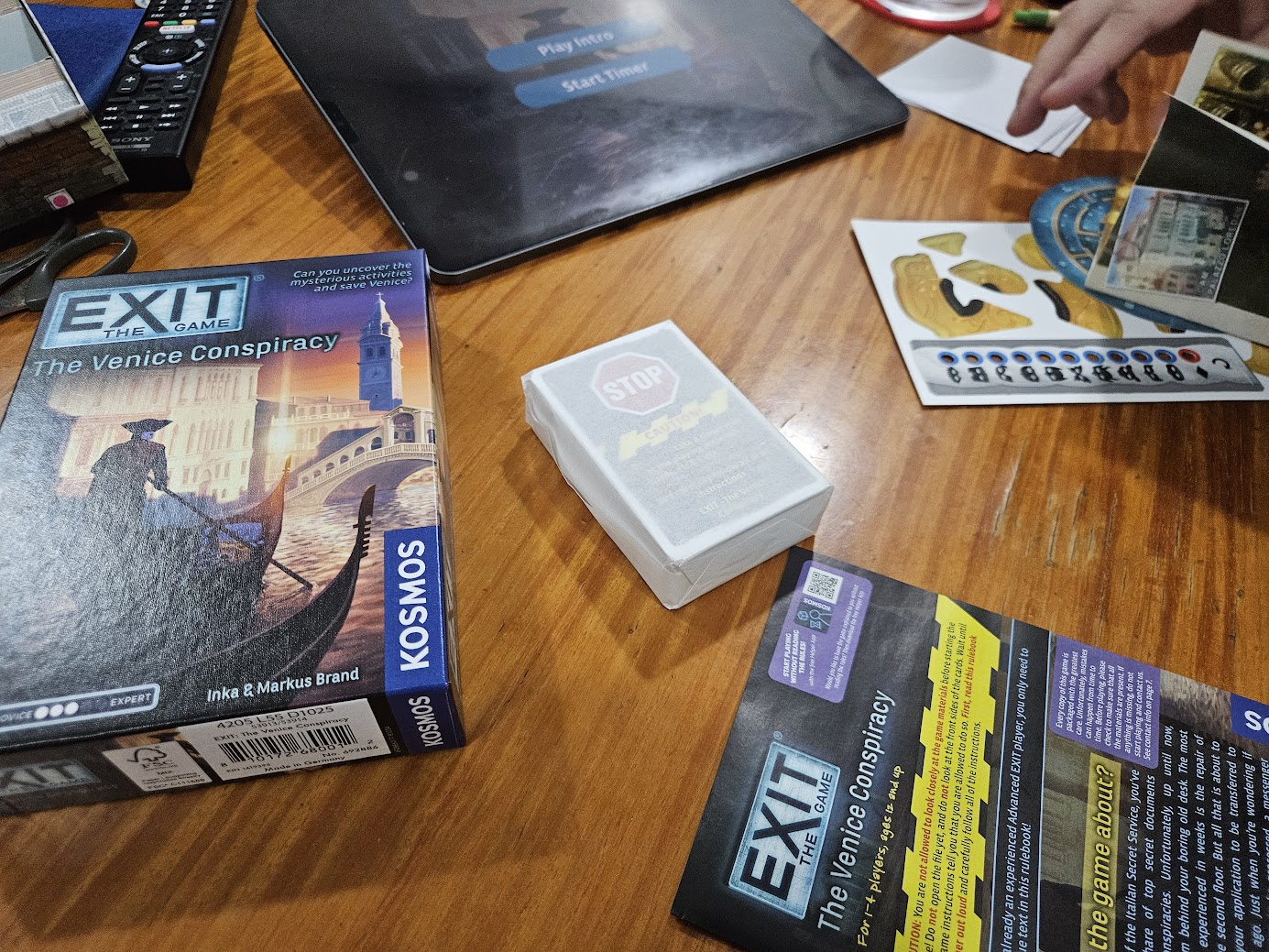 Gameplay photo of the board game EXIT: The Game – The Venice Conspiracy featuring various components and board state.