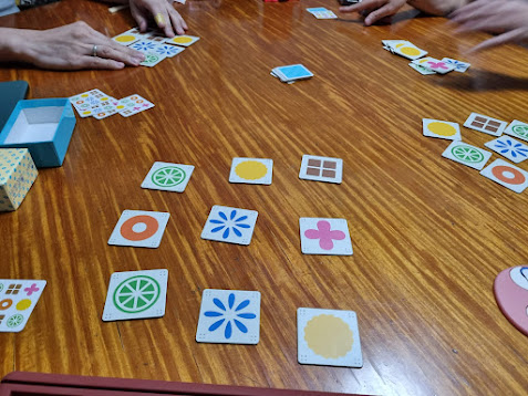 Gameplay photo of the board game Nine Tiles featuring various components and board state.