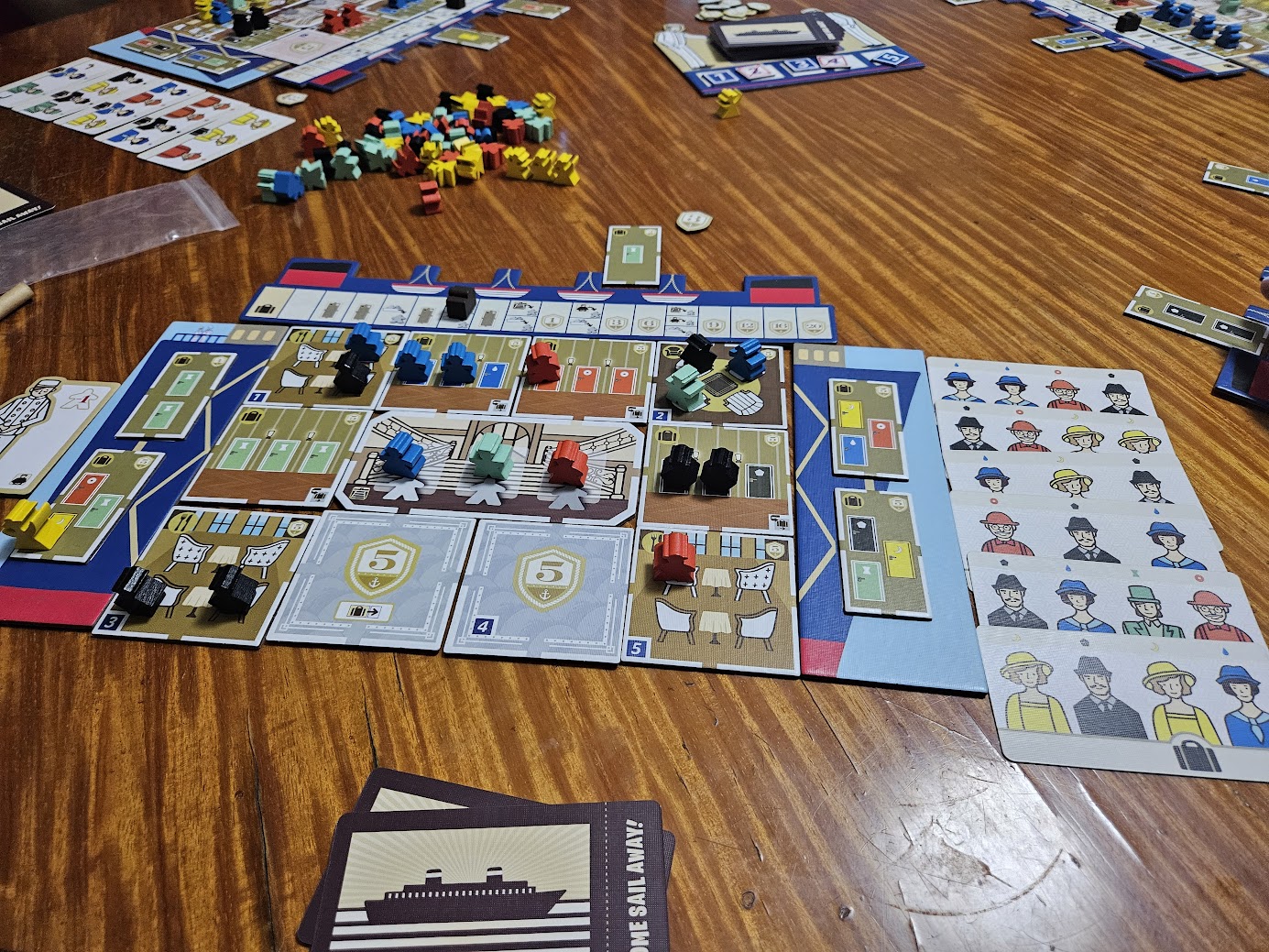 Gameplay photo of the board game Come Sail Away! featuring various components and board state.