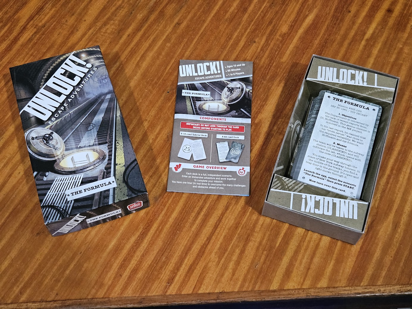 Gameplay photo of the board game Unlock!: Escape Adventures – The Formula featuring various components and board state.