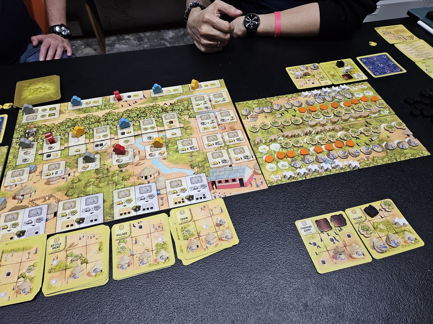 Gameplay photo of the board game Atiwa featuring various components and board state.