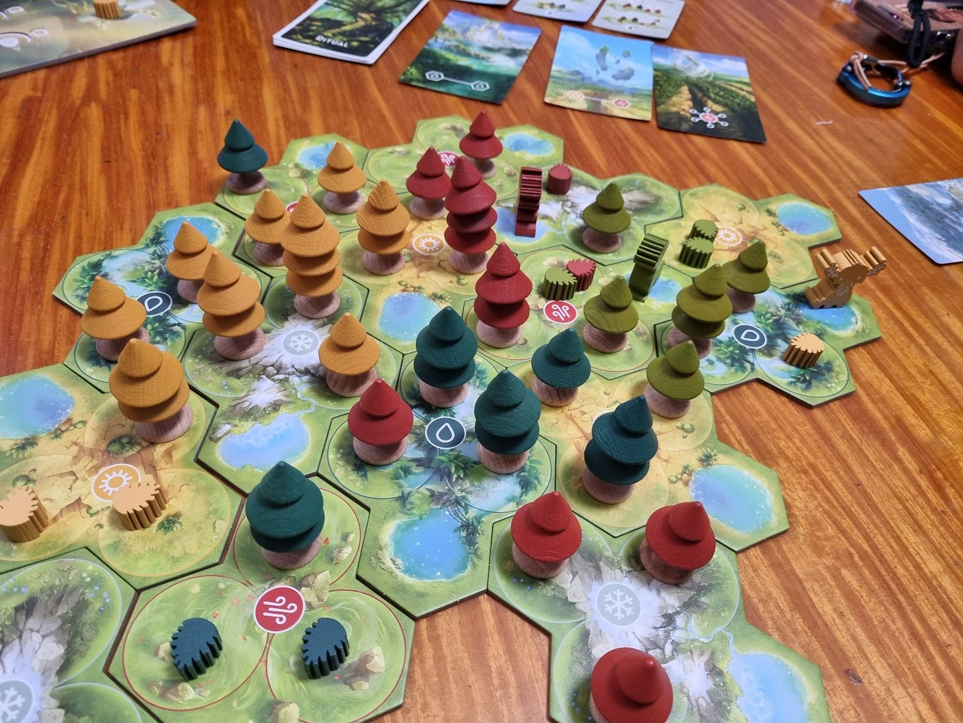 Gameplay photo of the board game Forests of Pangaia featuring various components and board state.