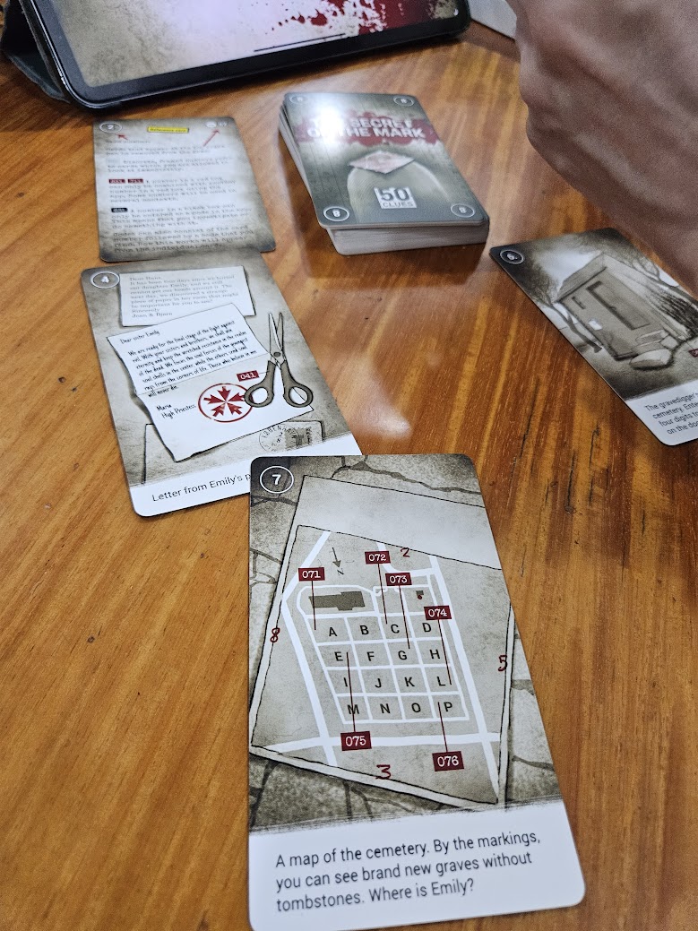 Gameplay photo of the board game 50 Clues: The Secret of the Mark featuring various components and board state.