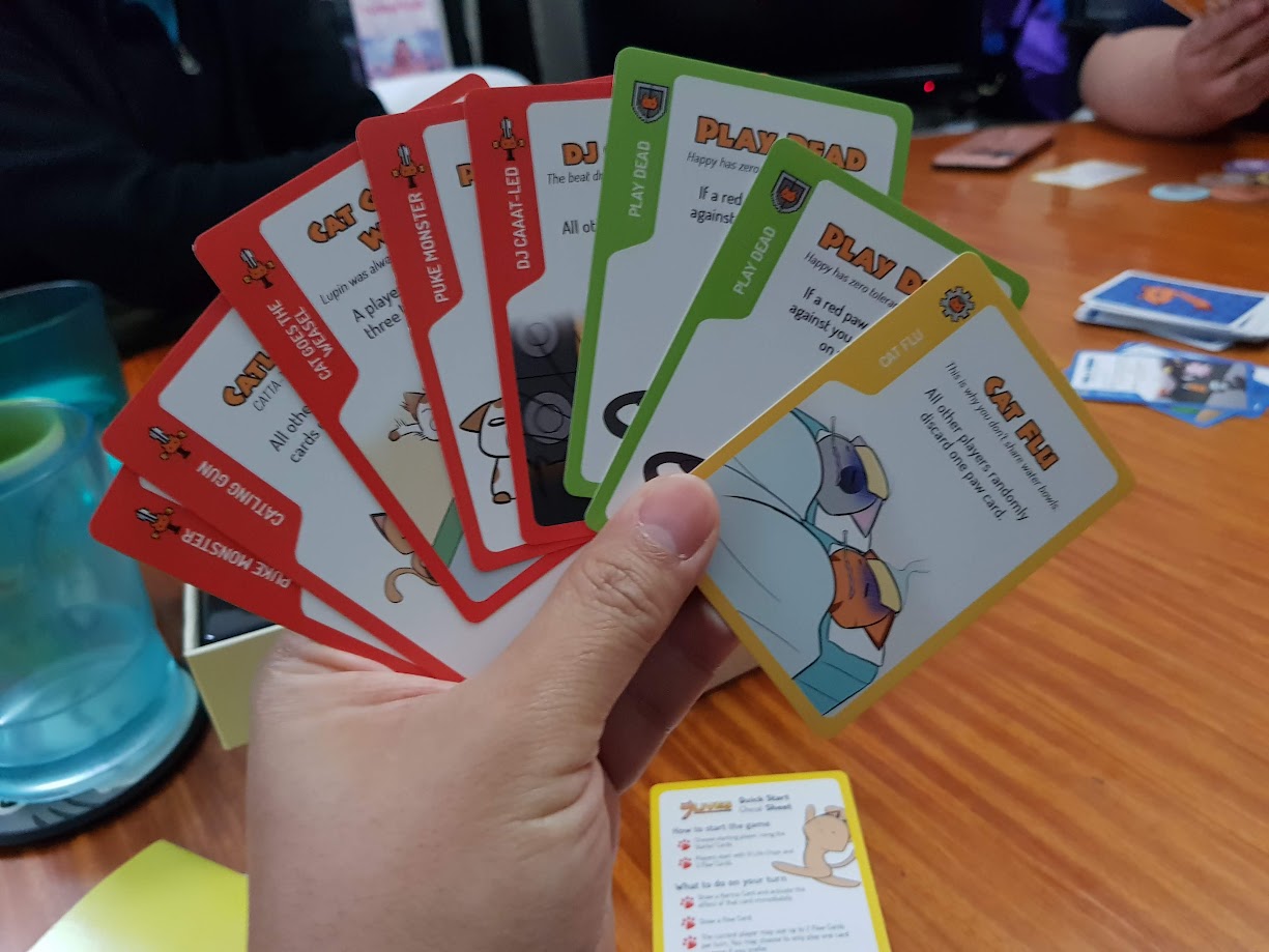 Gameplay photo of the board game 9 Lives featuring various components and board state.
