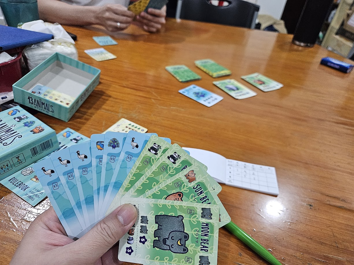 Gameplay photo of the board game 13 Animals featuring various components and board state.