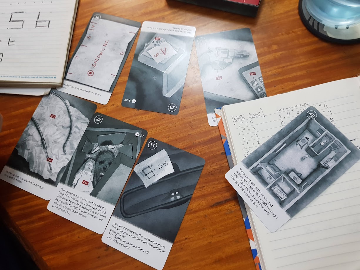 Gameplay photo of the board game 50 Clues: White Sleep featuring various components and board state.