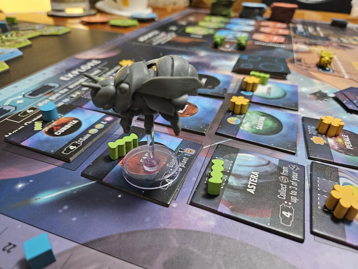 Gameplay photo of the board game Apiary featuring various components and board state.