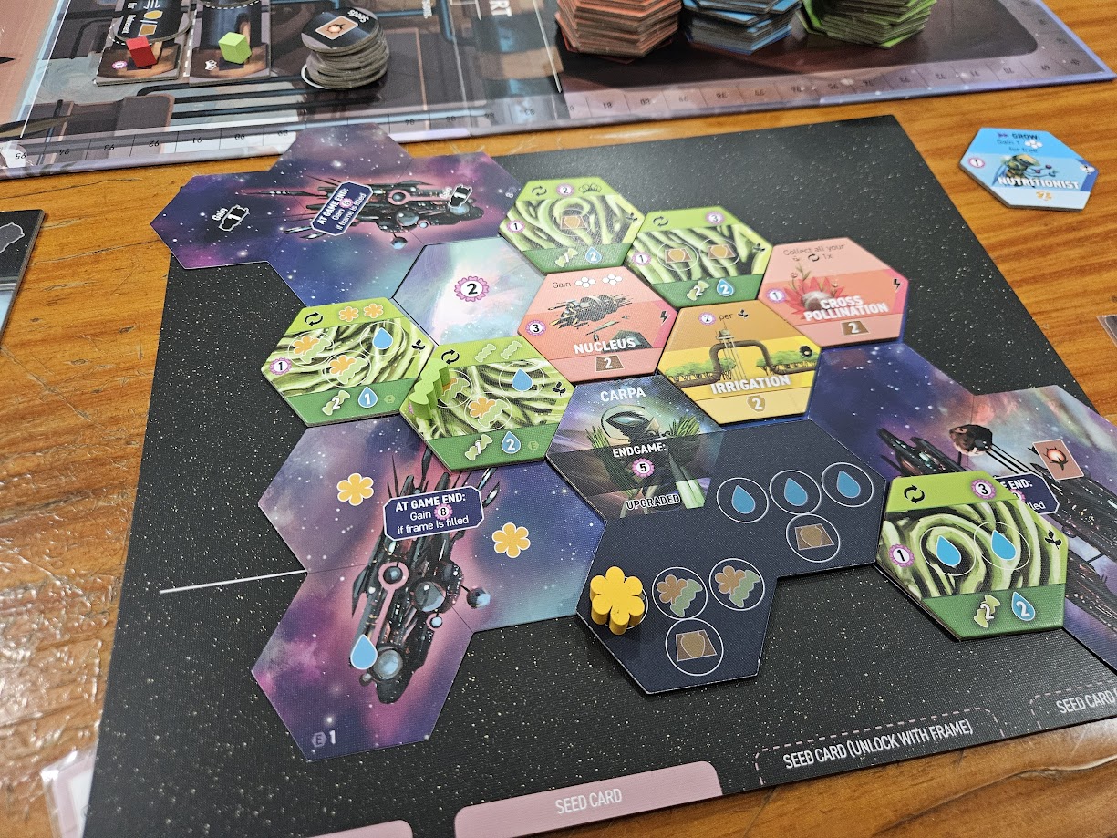 Gameplay photo of the board game Apiary: Expanding the Hive featuring various components and board state.