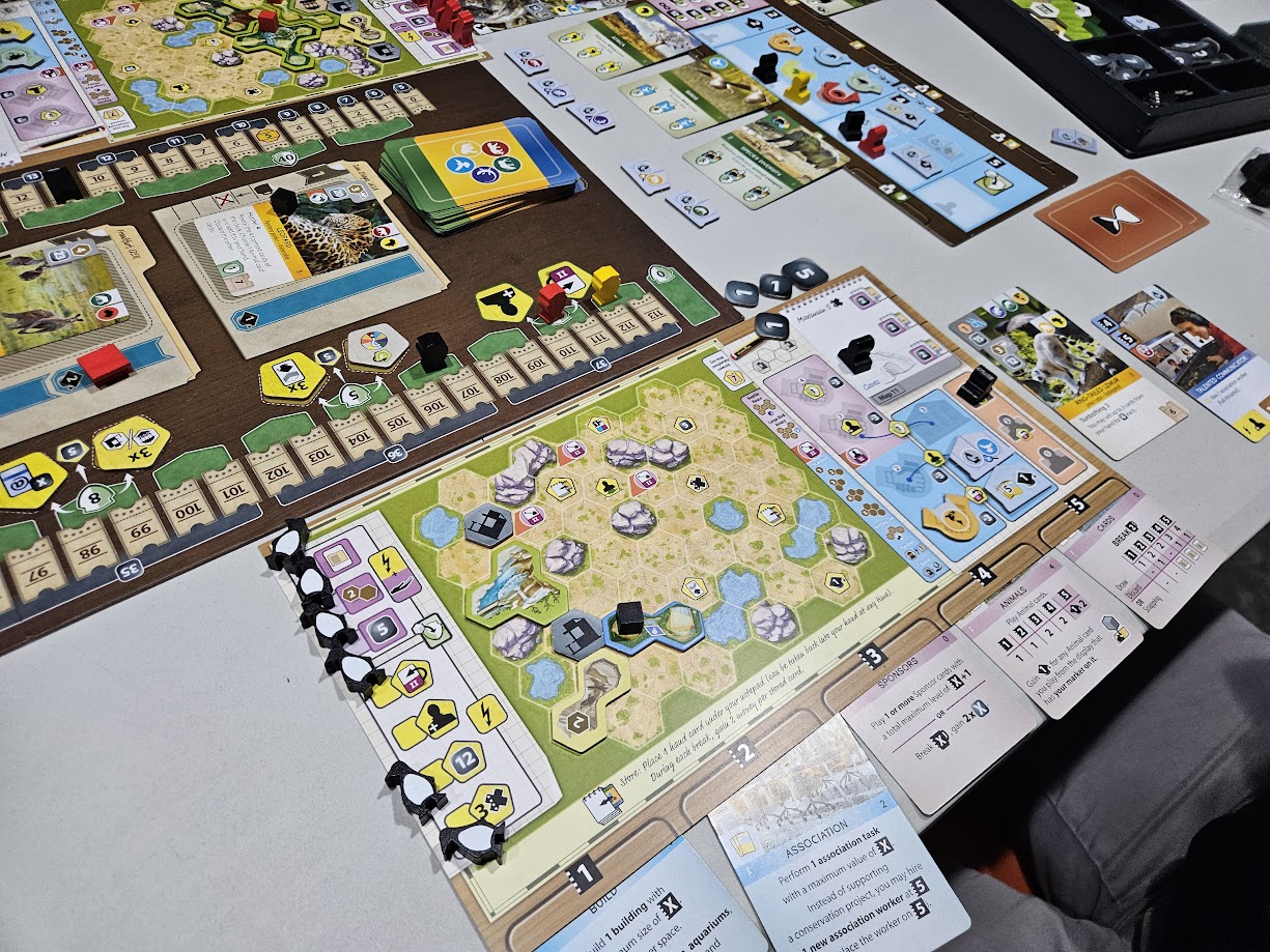 Gameplay photo of the board game Ark Nova: Marine Worlds featuring various components and board state.