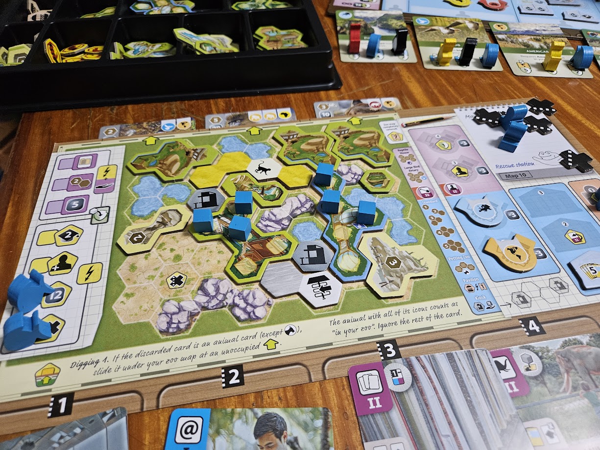 Gameplay photo of the board game Ark Nova: Zoo Map Pack 1 featuring various components and board state.