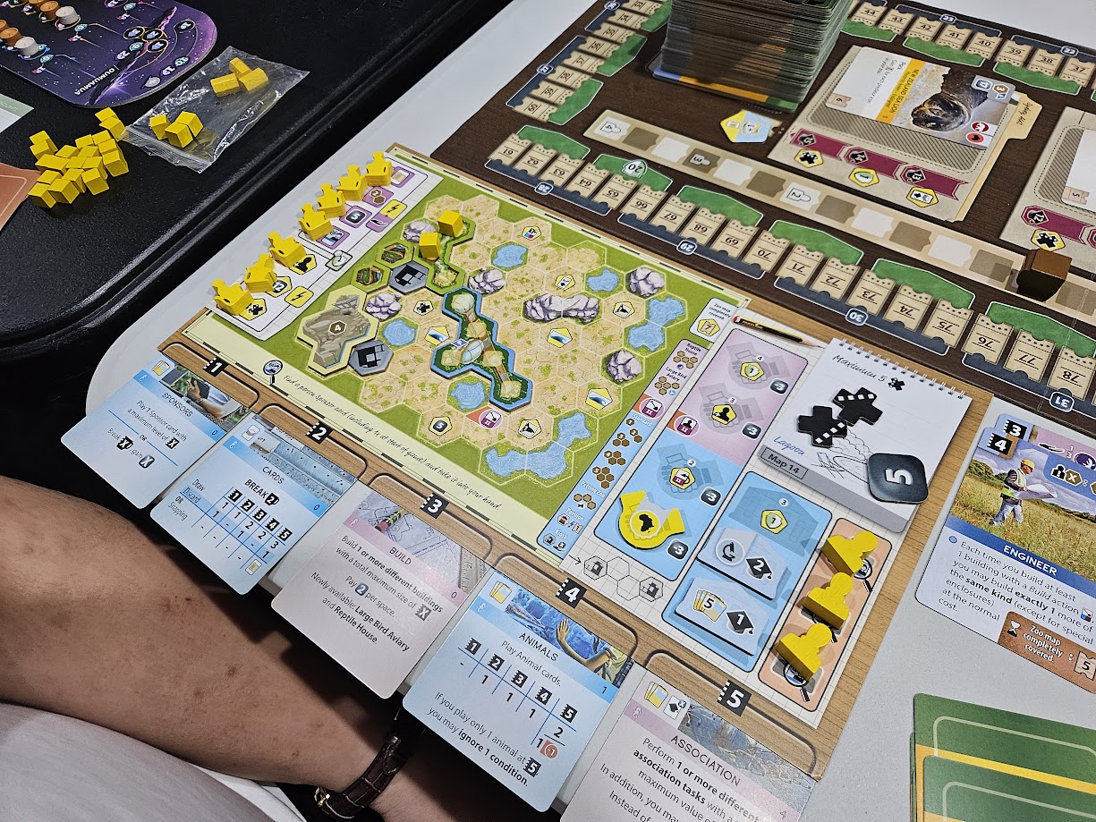 Gameplay photo of the board game Ark Nova: Zoo Map Pack 2 featuring various components and board state.