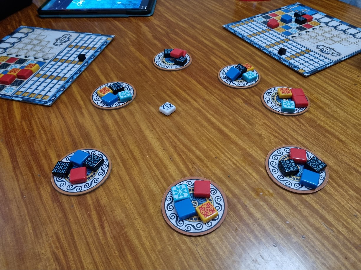 Gameplay photo of the board game Azul featuring various components and board state.