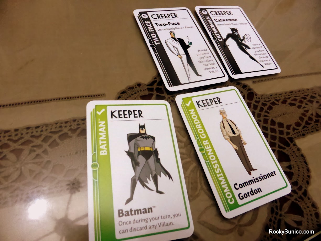 Gameplay photo of the board game Batman Fluxx featuring various components and board state.
