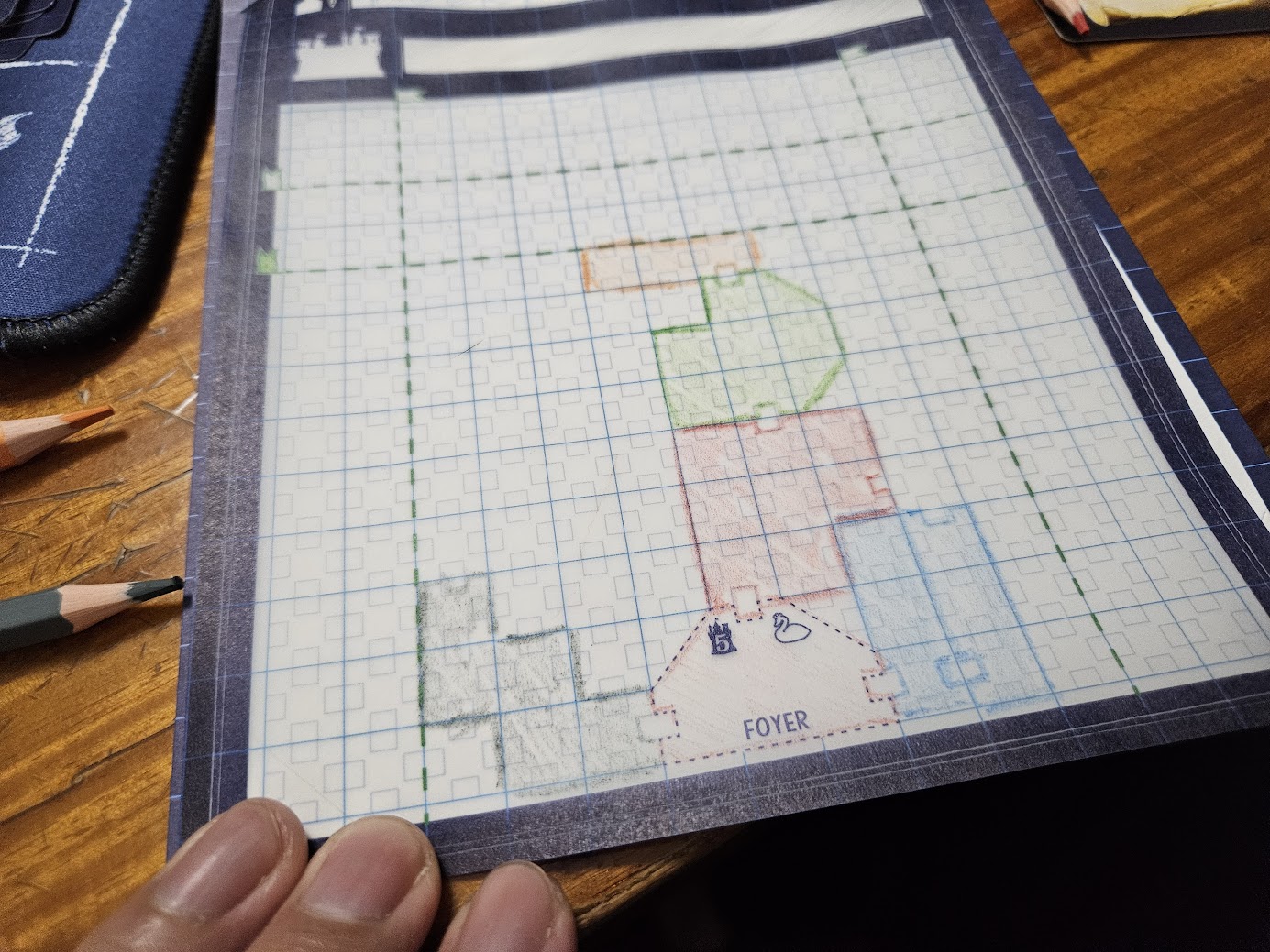 Gameplay photo of the board game Blueprints of Mad King Ludwig featuring various components and board state.