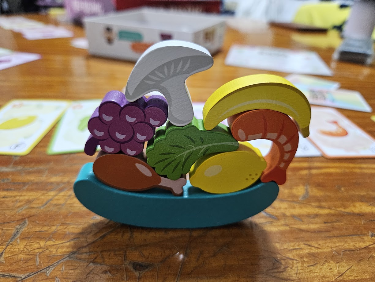 Gameplay photo of the board game Buffet Boss featuring various components and board state.