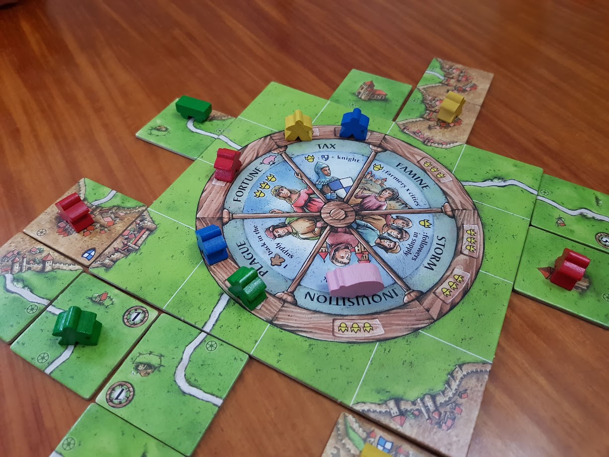 Gameplay photo of the board game Carcassonne: Wheel of Fortune featuring various components and board state.