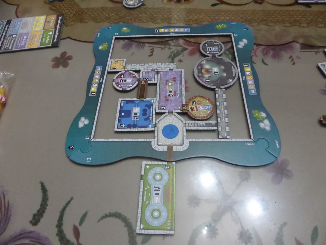 Gameplay photo of the board game Castles of Mad King Ludwig: Secrets featuring various components and board state.
