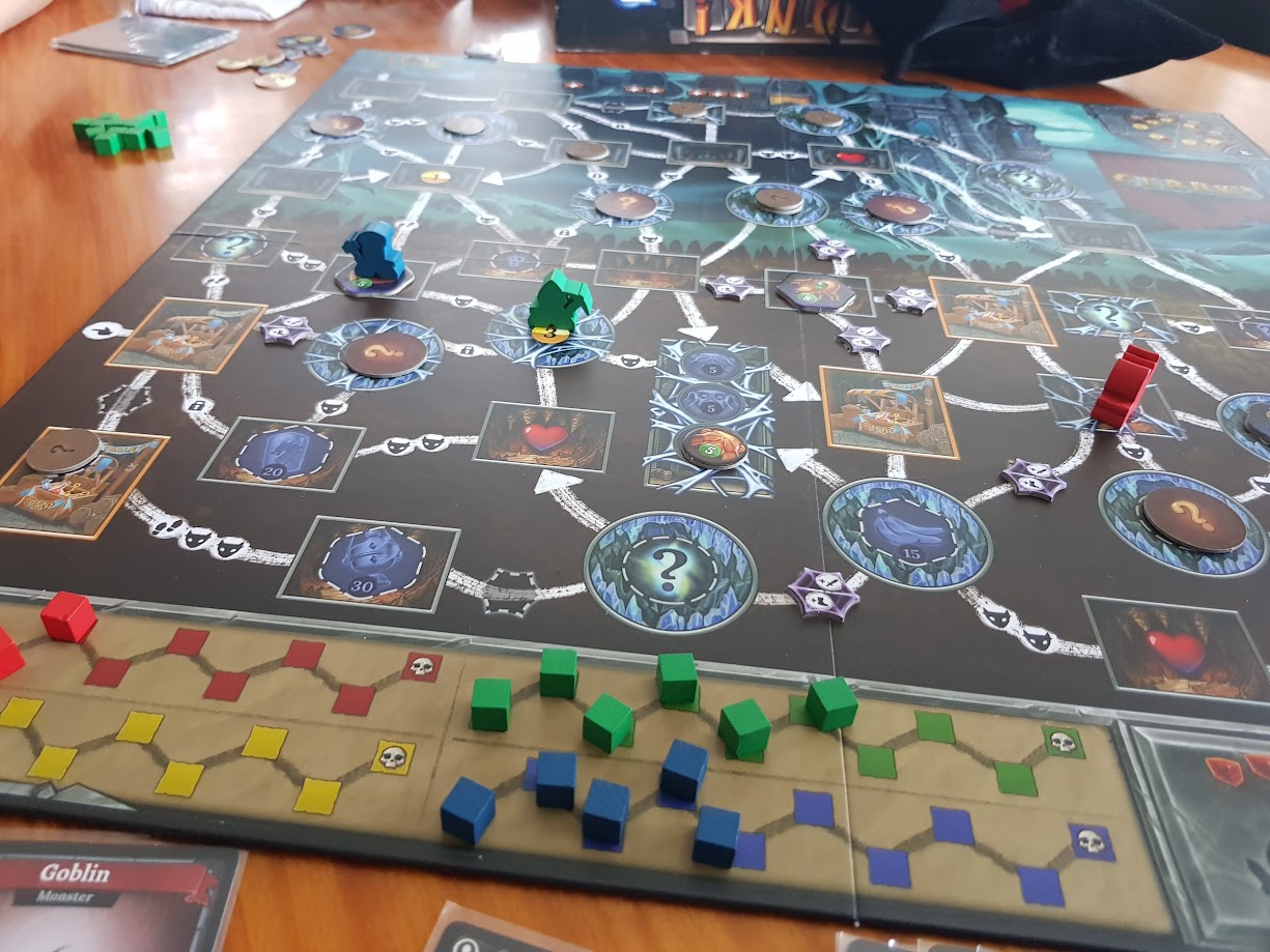 Gameplay photo of the board game Clank! Expeditions: Gold and Silk featuring various components and board state.