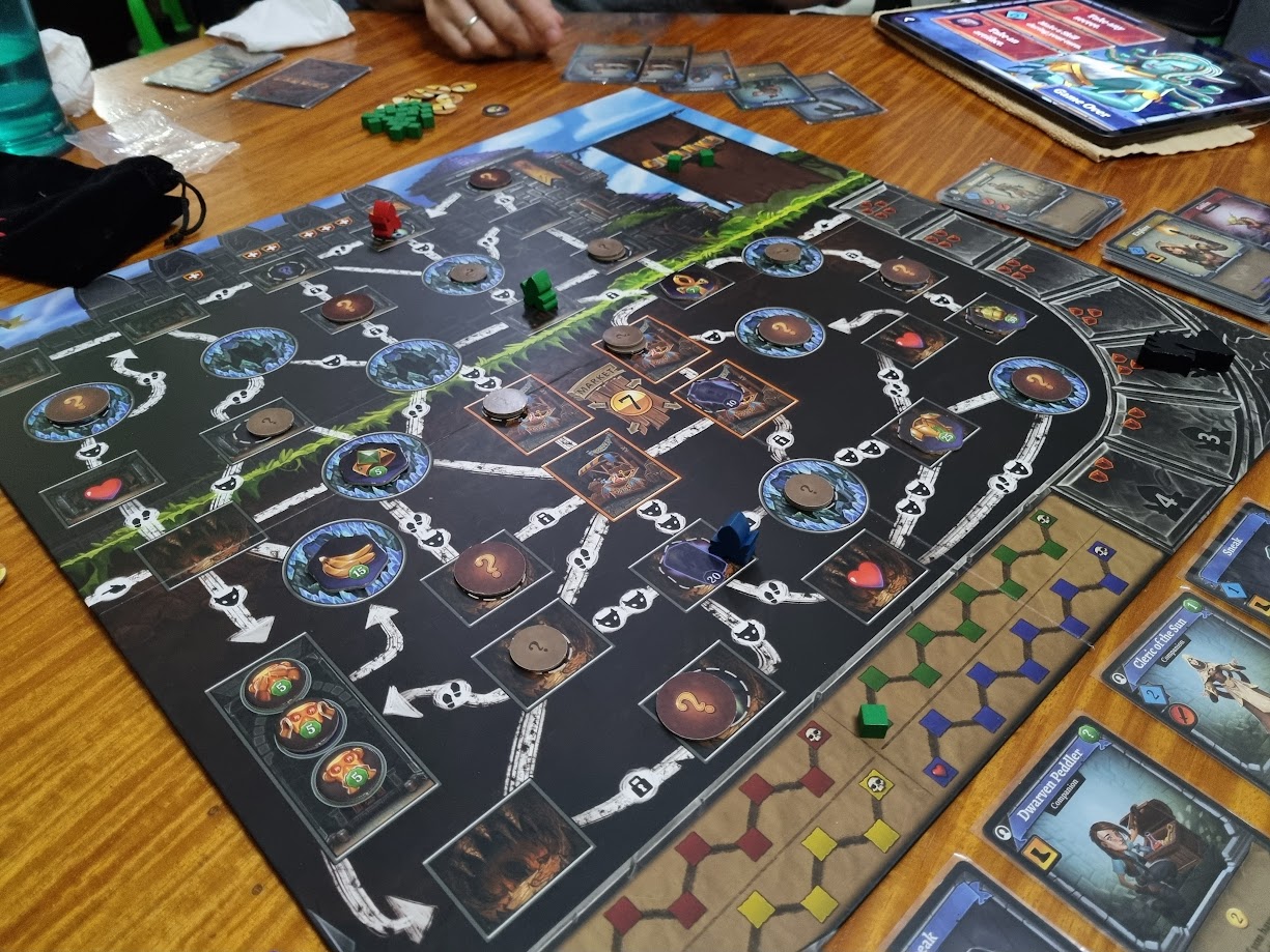 Gameplay photo of the board game Clank!: A Deck-Building Adventure featuring various components and board state.