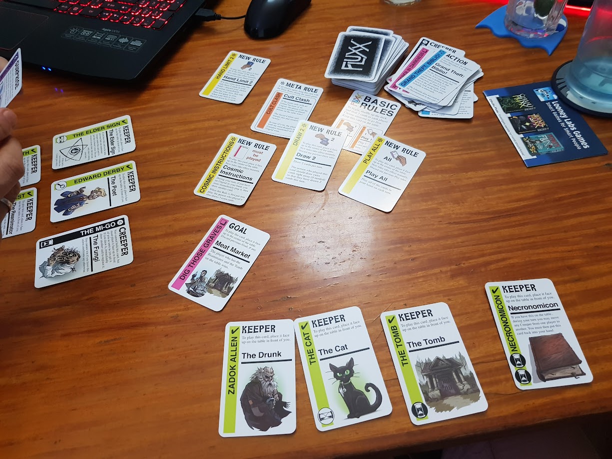 Gameplay photo of the board game Cthulhu Fluxx featuring various components and board state.