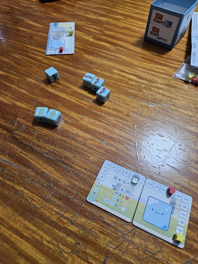 Gameplay photo of the board game CubeMelt: Getting Dicey featuring various components and board state.