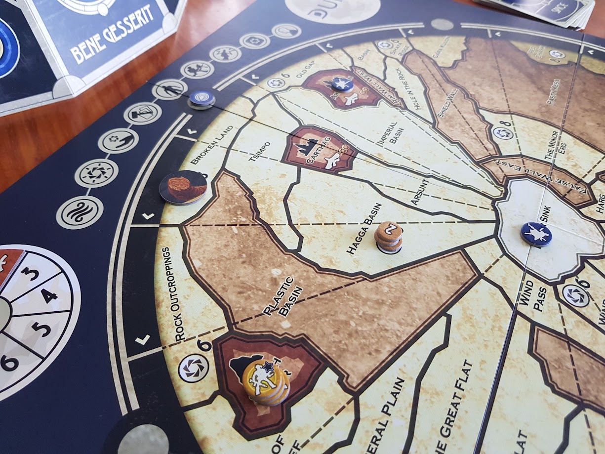 Gameplay photo of the board game Dune featuring various components and board state.