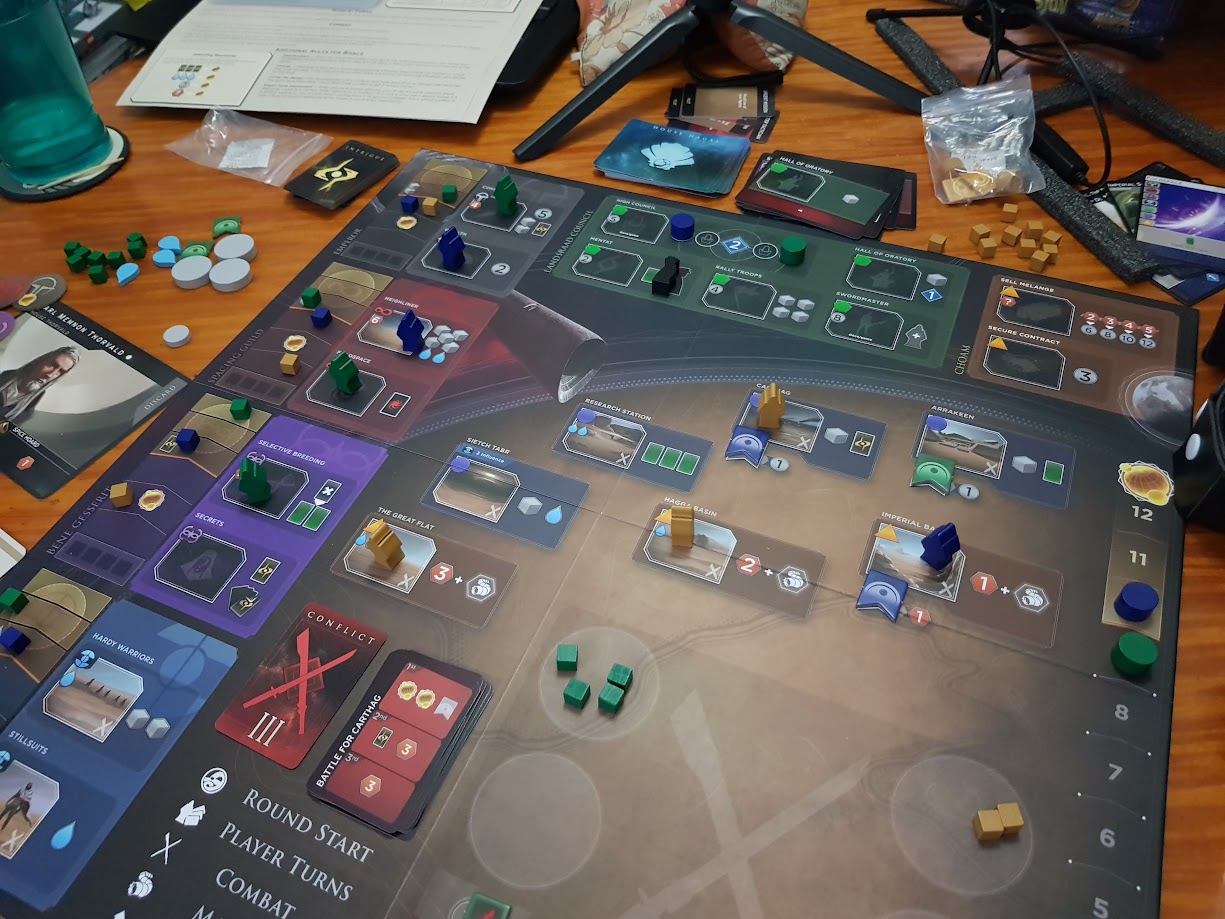 Gameplay photo of the board game Dune: Imperium featuring various components and board state.