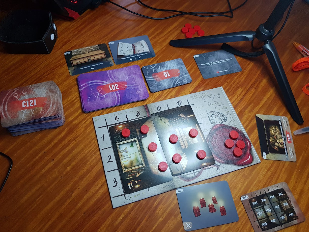 Gameplay photo of the board game Escape Tales: The Awakening featuring various components and board state.