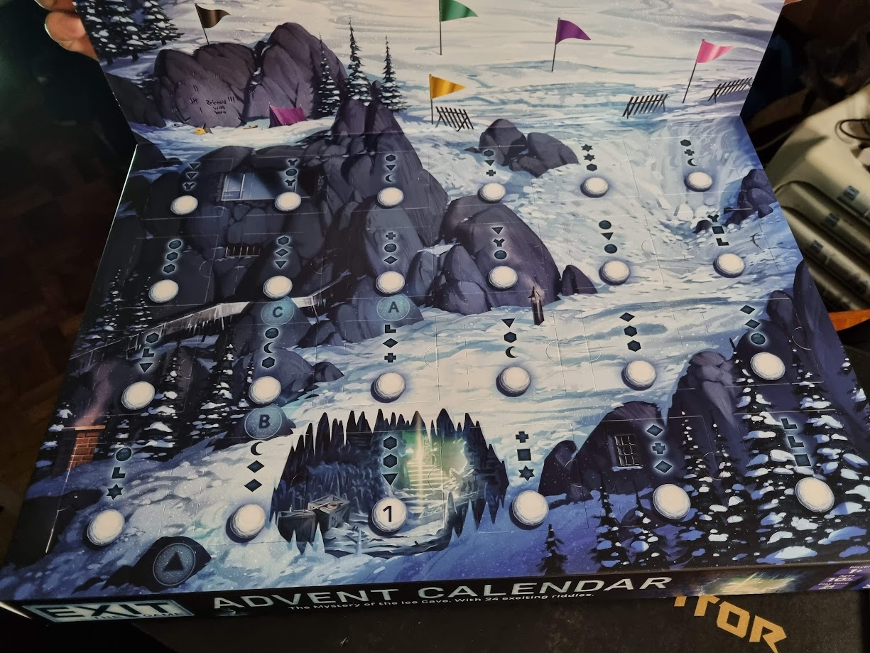 Gameplay photo of the board game EXIT: The Game – Advent Calendar: The Mystery of the Ice Cave featuring various components and board state.