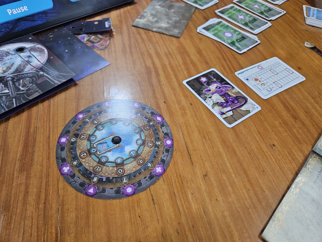 Gameplay photo of the board game EXIT: The Game – The Magical Academy featuring various components and board state.