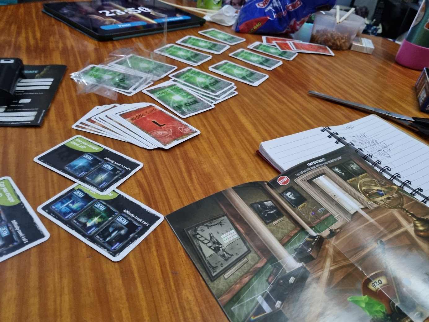 Gameplay photo of the board game EXIT: The Game – The Mysterious Museum featuring various components and board state.
