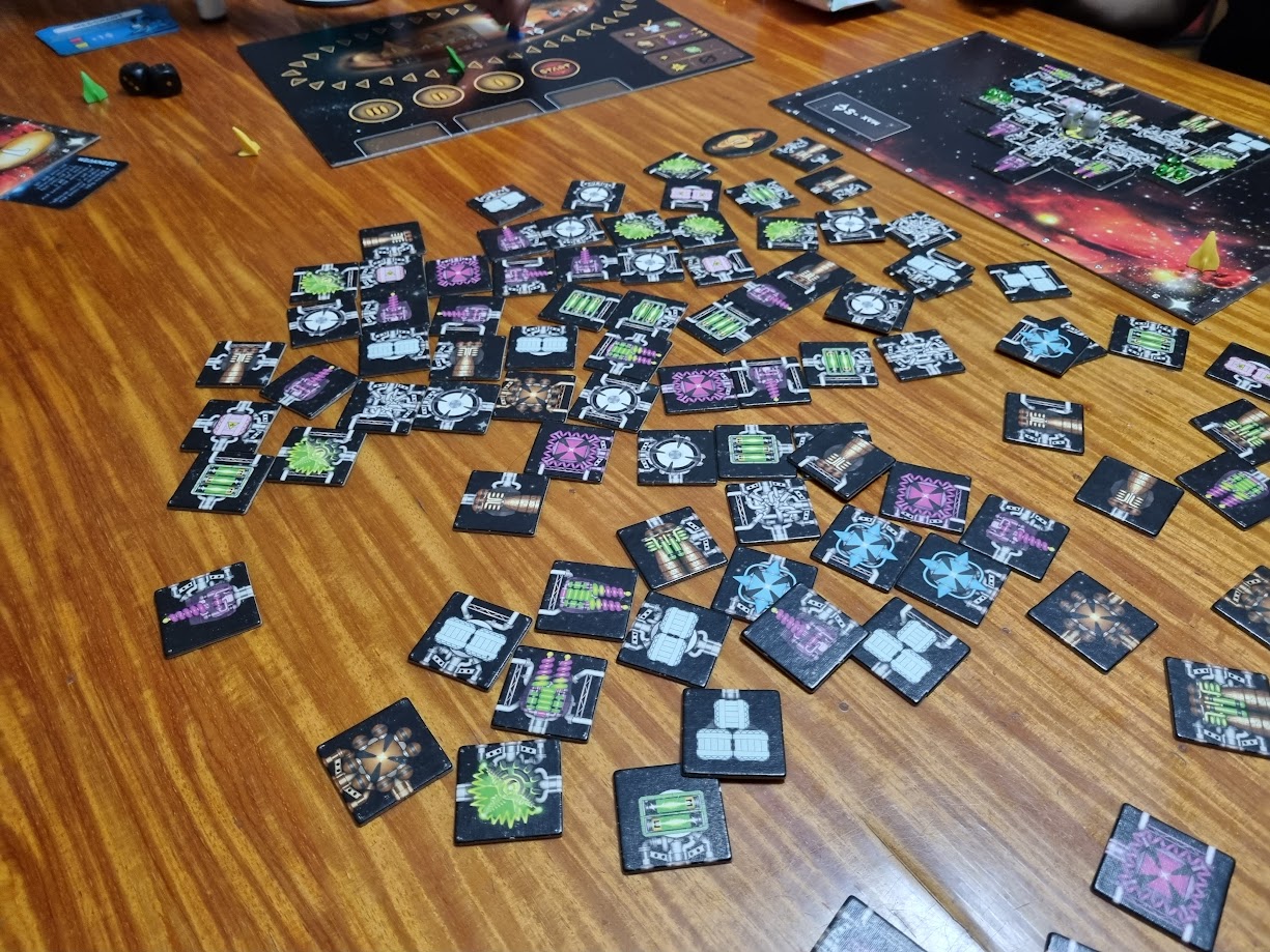 Gameplay photo of the board game Galaxy Trucker: Anniversary Edition featuring various components and board state.