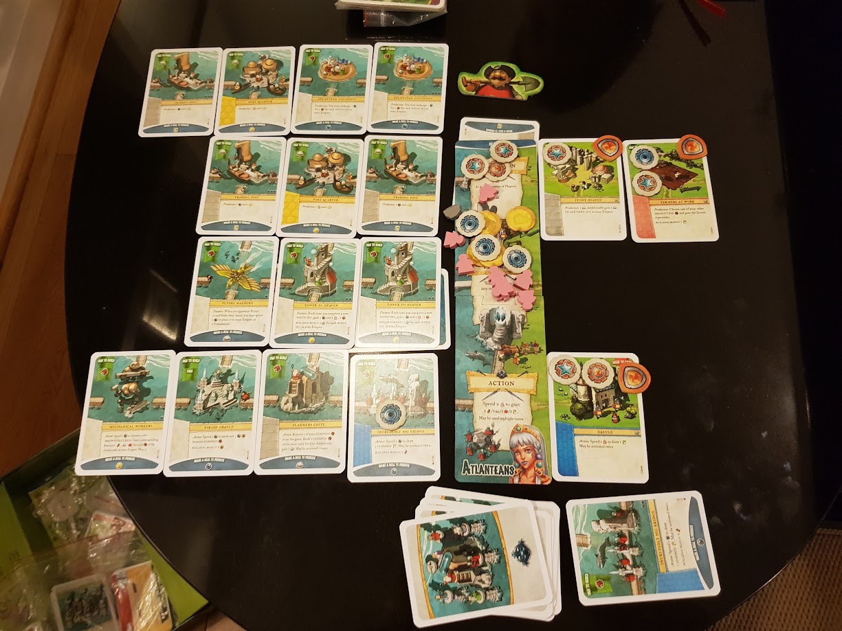 Gameplay photo of the board game Imperial Settlers: Atlanteans featuring various components and board state.