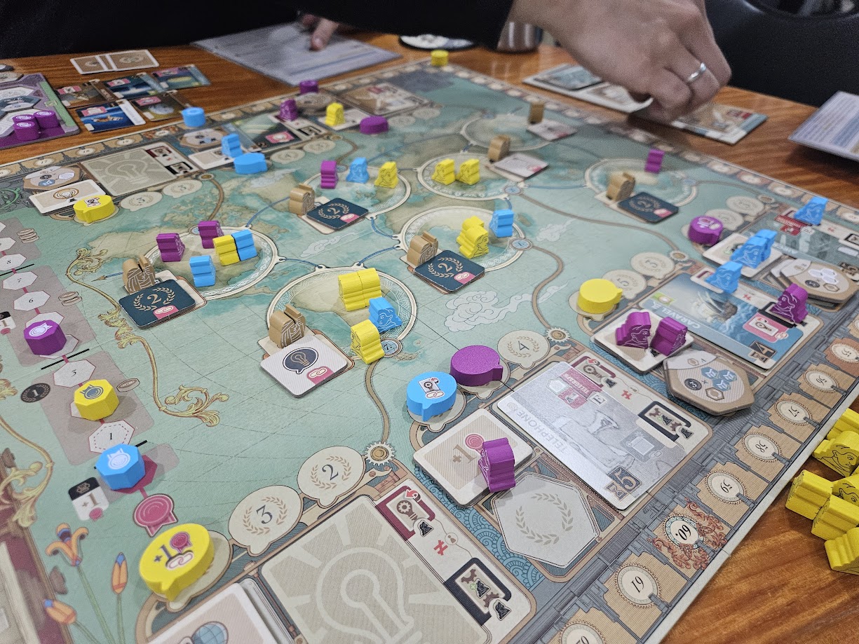 Gameplay photo of the board game Inventions: Evolution of Ideas featuring various components and board state.