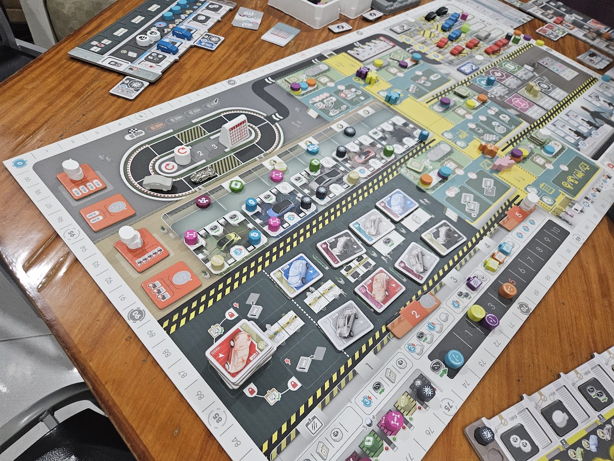 Gameplay photo of the board game Kanban EV featuring various components and board state.