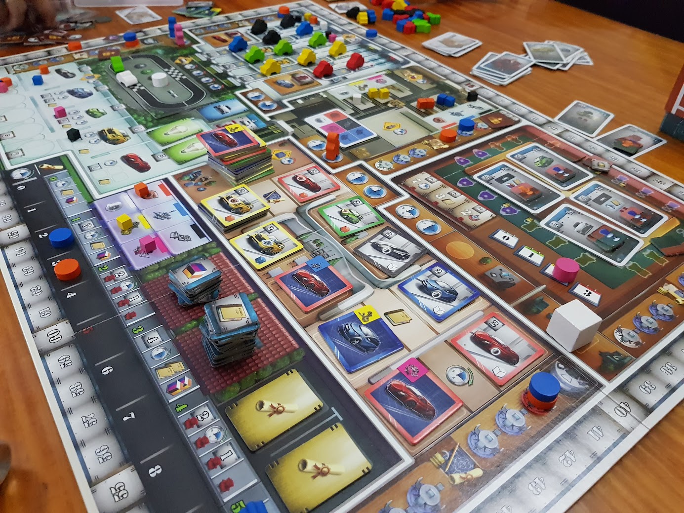 Gameplay photo of the board game Kanban: Automotive Revolution featuring various components and board state.