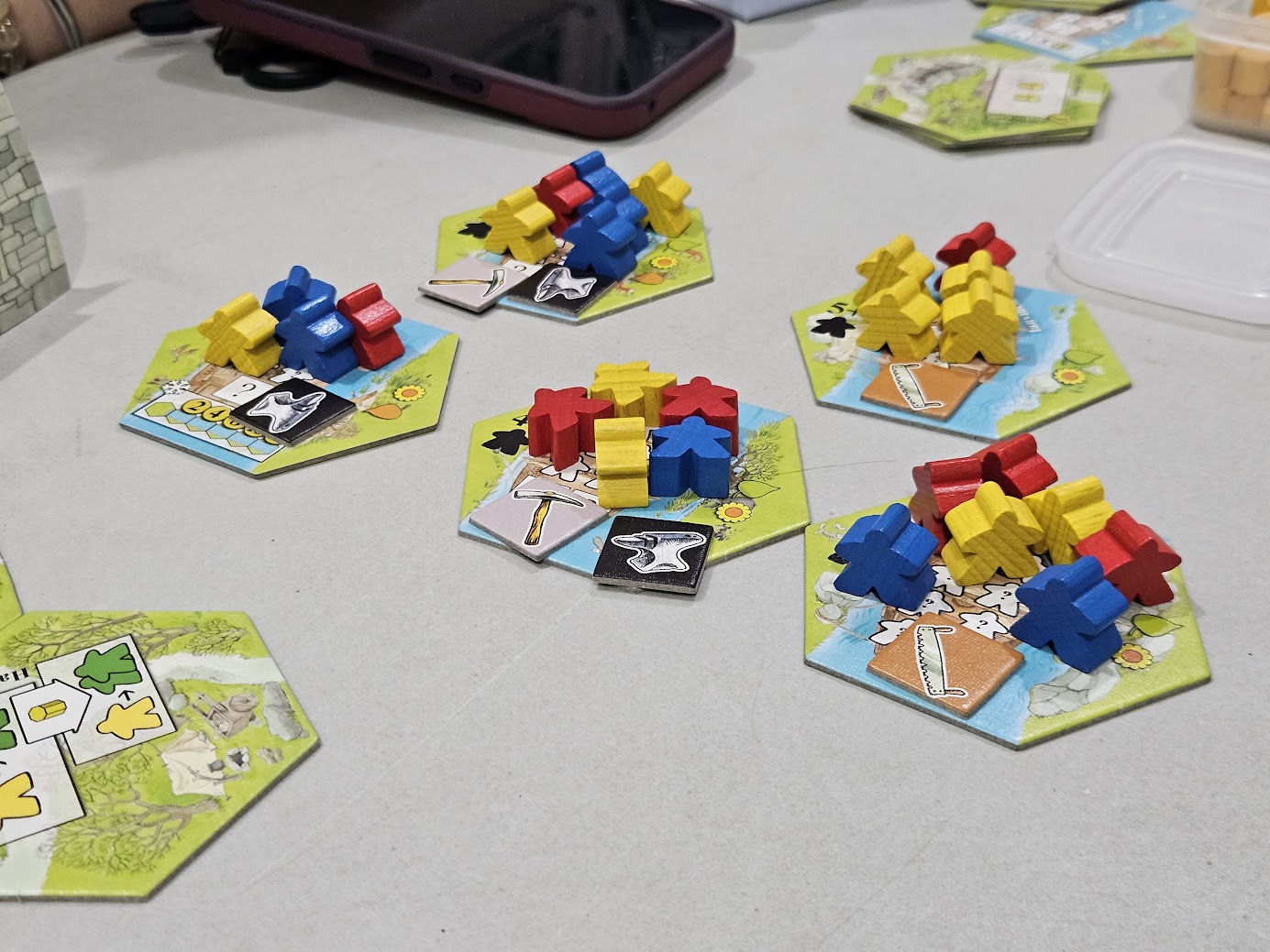 Gameplay photo of the board game Keyflower featuring various components and board state.