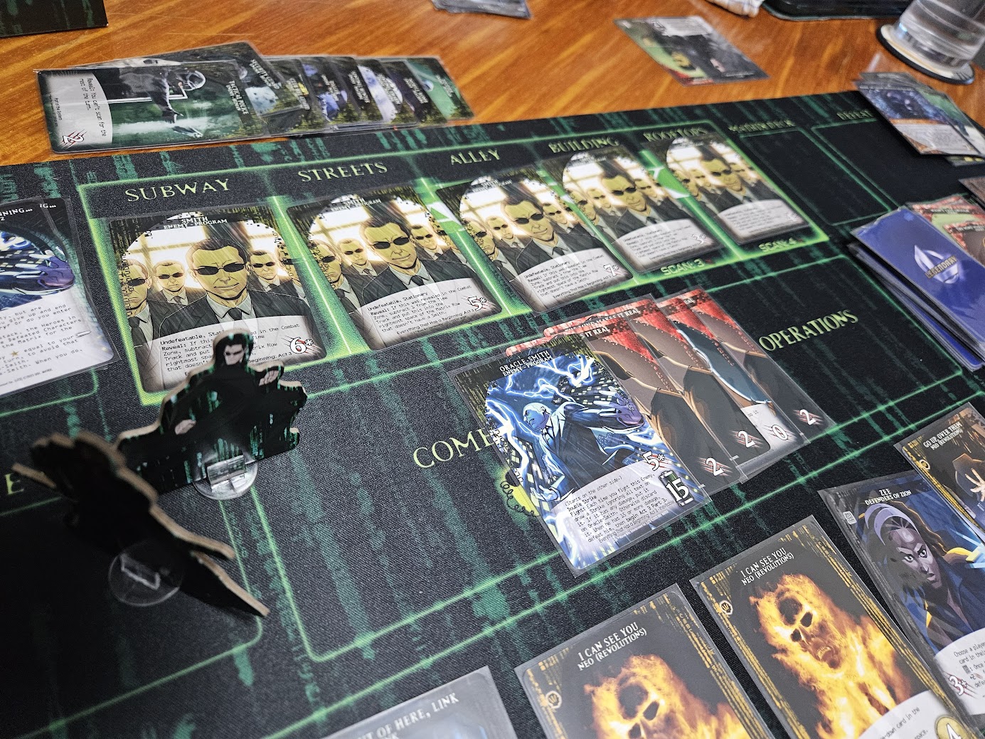 Gameplay photo of the board game Legendary Encounters: The Matrix featuring various components and board state.