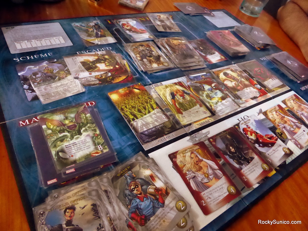 Gameplay photo of the board game Legendary: A Marvel Deck Building Game featuring various components and board state.