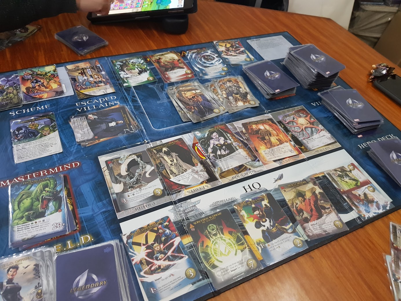 Gameplay photo of the board game Legendary: A Marvel Deck Building Game – Secret Wars, Volume 2 featuring various components and board state.