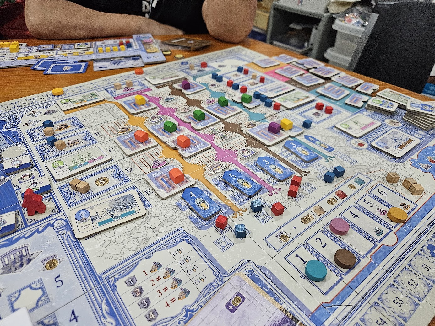 Gameplay photo of the board game Lisboa featuring various components and board state.