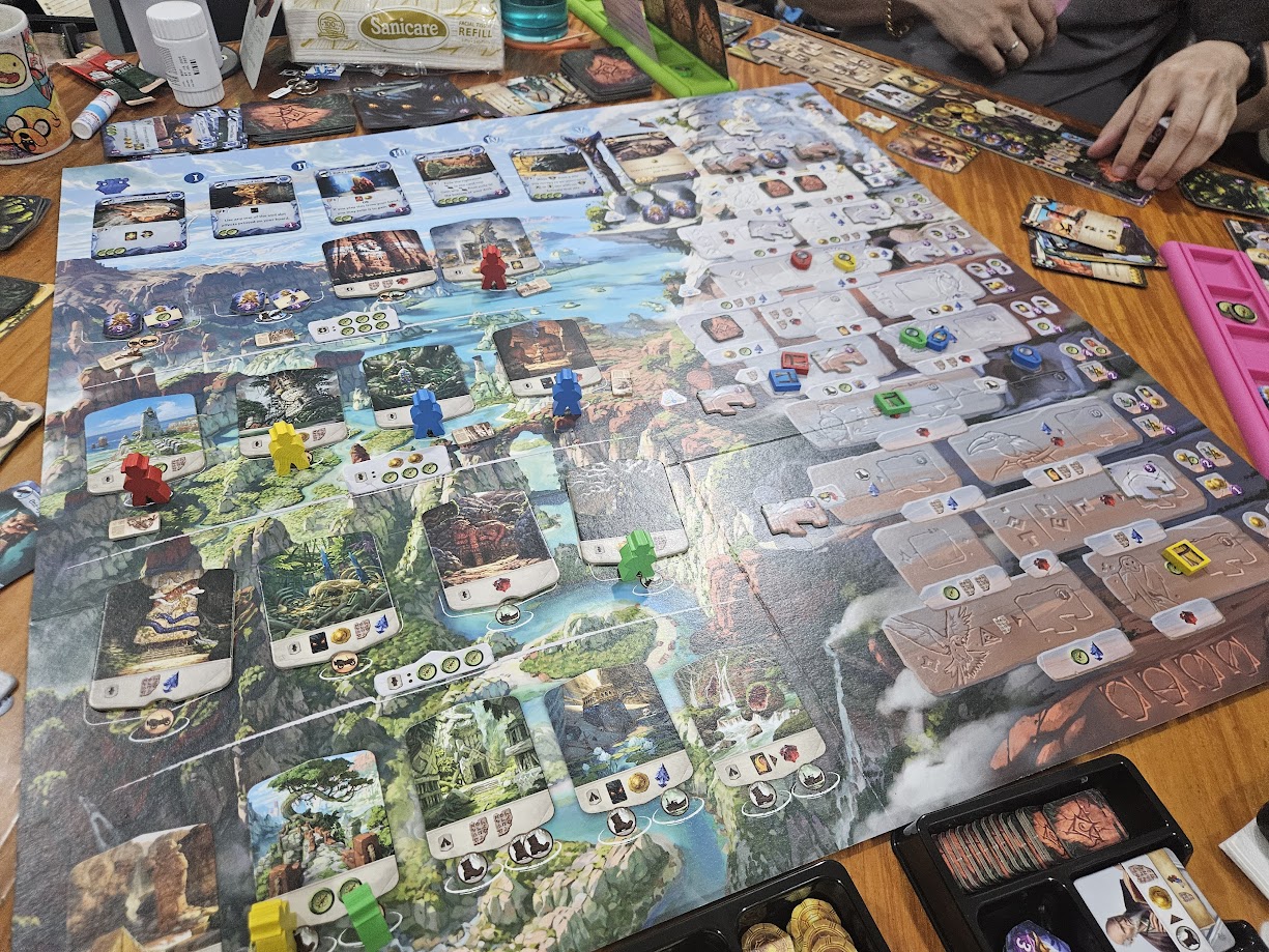 Gameplay photo of the board game Lost Ruins of Arnak: Adventure Chest featuring various components and board state.