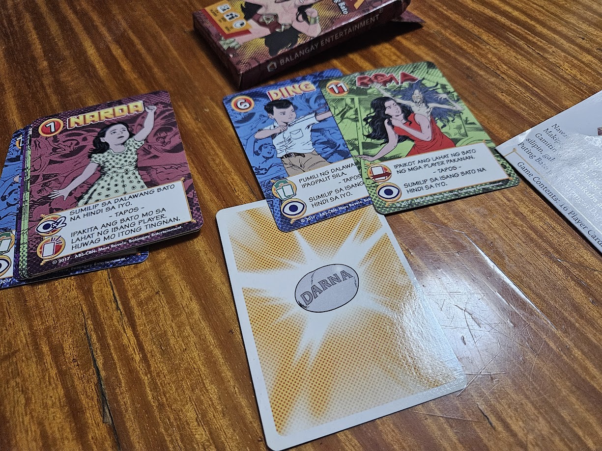 Gameplay photo of the board game Mars Ravelo's Darna at ang Nawawalang Bato featuring various components and board state.