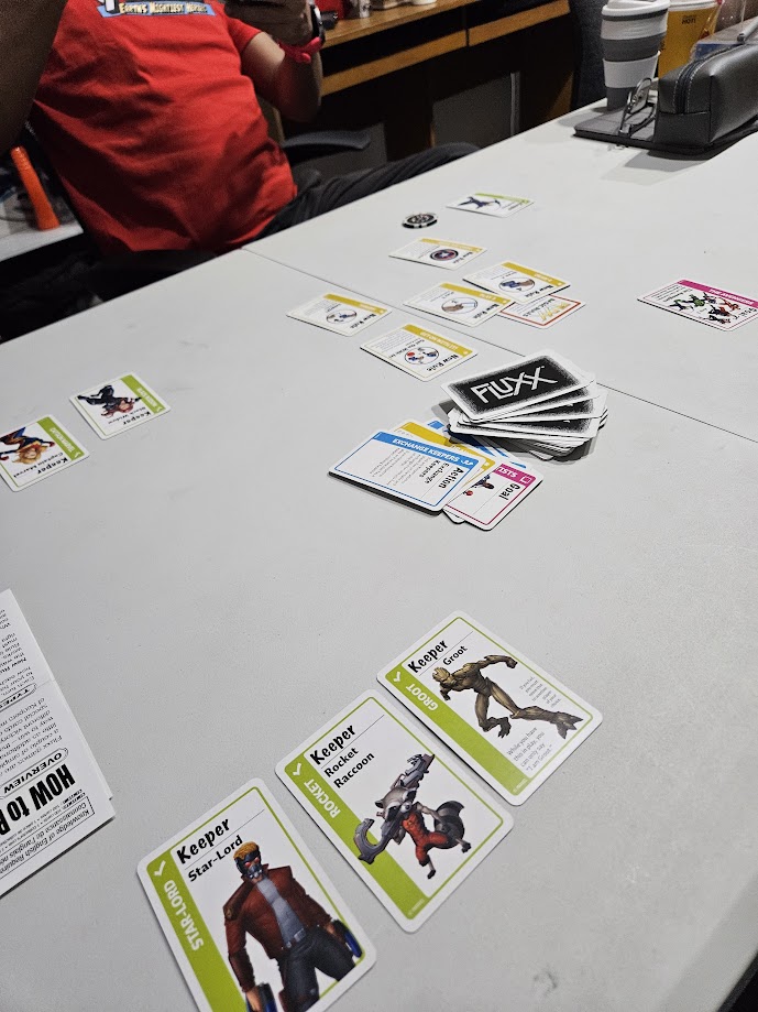 Gameplay photo of the board game Marvel Fluxx featuring various components and board state.